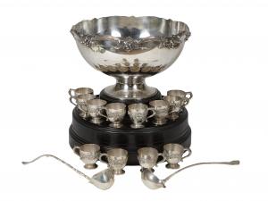Early 20th century 15-piece sterling silver punch set by Whiting, consisting of a large punchbowl, in a grape and vine motif, 12 matching punch cups, and two punch ladles (est. $4,000-$8,000).