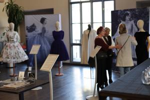 Visitors to the Couture Pattern Museum exhibition examining the authentically recreated black velvet Madame Gres gown