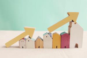 Wooden houses with yellow arrows up