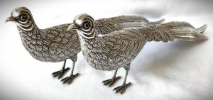 Lovely pair of circa 1950/1960 Spanish silver pheasants table toys with dark ruby glass eyes (est. $1,000-$2,500).