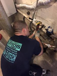 Flotechs Plumber working on emergency pipe repair in Yonkers home