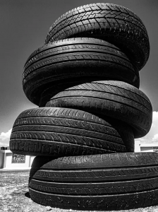 Black and white photo of tires stacked on one another