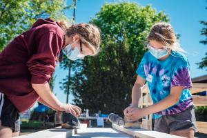 2 volunteers helping build a headboard