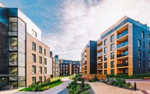 Modern new development property. European style with earthy tones. Blue sky background.
