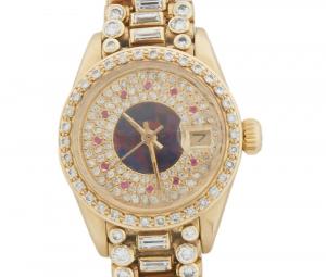 Lady's 18kt yellow gold Rolex Date Just watch with diamond and ruby chapter marks and an octopus band mounted with two round diamonds flanking a central diamond (est. $3,000-$5,000)