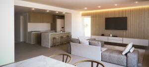 Artist Townhomes Living Room with Wood Slate Wall and Modern Kitchen