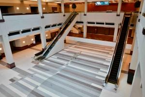 Terrazzo patterning and brass strips show action lines tracing the movement of boaters in the water.
