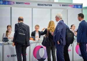 Industry professionals collect their badges for entry at Identity Week Europe 2022