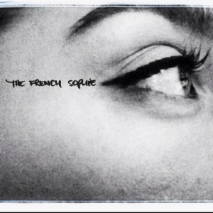 Black and white closeup photo of a woman's right eye and eyebrow looking out right. The woman is wearing eyeliner. The eyeliner is aligned with the company's name THE FRENCH SOPHIE written on the woman's right temple.