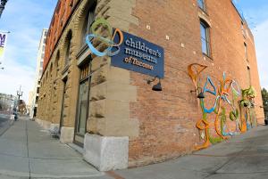 Colorful public wall art called Wall-Ish in front of the Children's Museum of Tacoma