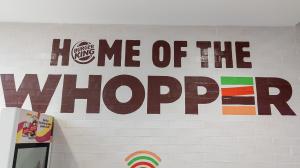 Sign that reads "Home of the Whopper" at a Burger King store