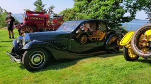 A Vintage Bugatti arriving at Misselwood Concours d'Elegance with the ocean in the background