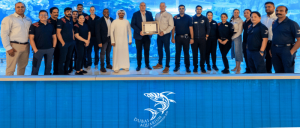 Emaar Entertainment Dubai Aquarium and Underwater Zoo Leadership and team in group photo receiving the CAC framed certificate from IBCCES