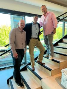Cole Houston COO Parcel Path, Rich Mason GP Alpha Kingdom Capital, and Tucker Lemm CEO Parcel Path standing on the steps inside the office