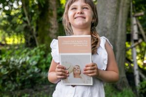 Image of girl, holding a beautiful kindred tales keepsake book