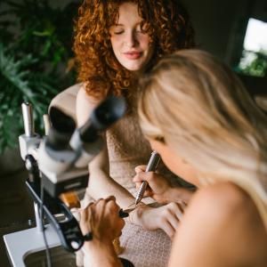 image of welder customizing permanent jewelry on a client
