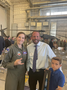 Photo of two adults and one kid at Air Force Base accepting exceptional honor