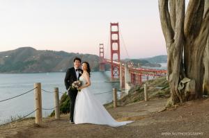 A couple enjoying the Golden Gate Bridge at the Presidio in San Francisco