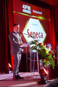 Ben Rogers, Dean of Applied Research, presents the Startup Award, for the Aspire Awards series sponsored by Seneca College of Applied Arts and Technology for young professionals.