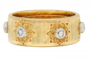 Italian-made Buccellati signed 18kt MACRI ring band featuring six white gold stations atop an engraved lace motif, centering a round brilliant cut 0.18 carat diamond (est. $4,000-$6,000).
