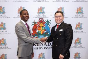 grenada prime minister Dickon Mitchell shaking hands with Hengsheng vp Galli khurelee infront of Grenada cbi poster stand