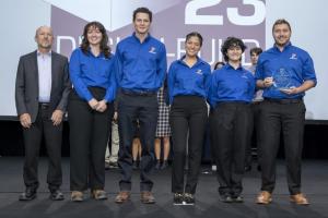 Group photo of student competition team from UF holding their award for winning DBIA's student competition