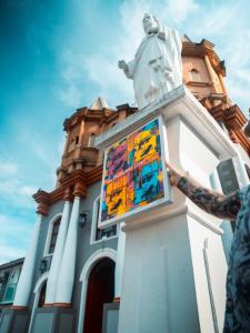 A photo of artist FLOODEDMIA in Colombia during a trip to develop and test the concept of his Paradise Lost exhibit.