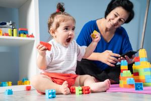 Nanny and baby play