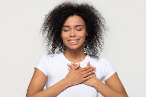 In a world full of uncertainty — climate crises, global conflicts, job instability and the constant pressures of modern life — it can feel impossible to find peace, joy or connection Woman with hands on her chest