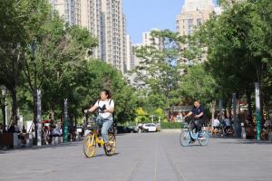 People cycling in a public space in Tianjin.