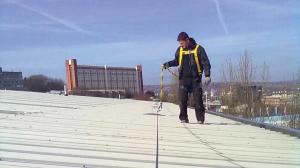 Heartland Construction and roofing worker using safety line protection