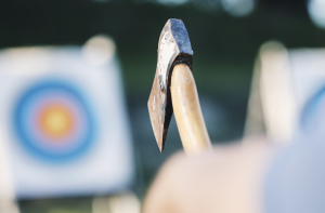 Man throwing an axe at a target.