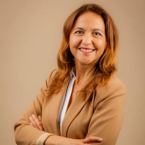 safia is a woman wearing a beige blazer suit and beige background