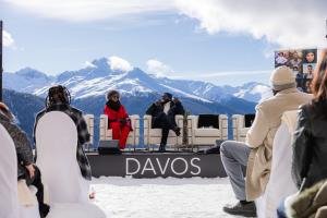 This picture features panelist Kweku Mandela and Adrianne C. Smith discussing the importance of DE&I at the iconic Snow Beach at the Hotel Schatzalp during the 2024 World Economic Forum Annual Meeting in Davos, Switzerland