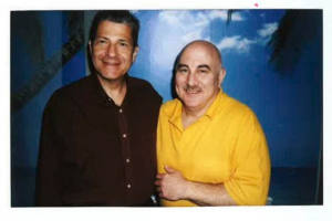 a photo of me with the infamous serial killer Son of Sam (David Berkowitz) standing in front of a hand painted beach mural in a maximum security prison.