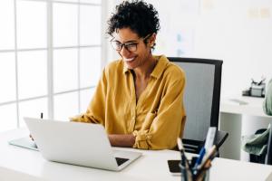 Happy african american office worker in gold shirt