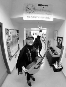 Canadian songwriter Rik Leaf inspires students with his music program "Songs For Schools," pictured here pointing to a hopeful message: "The Future Looks Good."