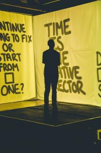 Elijah stands centre stage with his yellow squares projected in 360