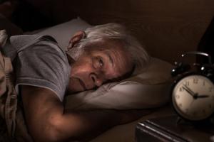 Senior_man_suffering_from_insomnia_lying_in_bed_unable_to_sleep