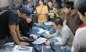 Designer Maurice Malone working inside a denim laundry factory in China