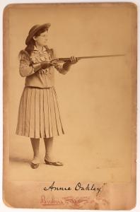 Cabinet card showing the legendary sharpshooter Annie Oakley, holding what appears to be a Lancaster shotgun as if ready for her next glass ball, Brisbois Studios (Chicago) ($1,312).