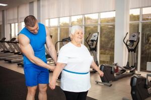 An Elderly Pensioner Plays Sports in the Gym