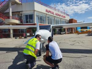 Student and instructor inspect the electric aircraft before flight on the tarmac