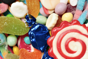 Various types of candies stacked on one another.