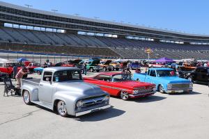Vintage cars and trucks lined up on the infieled of Texas Motor Speedway.