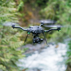 Freefly's NDAA-compiant Astro UAS flies in a wooded area