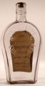 Frank Abadie pint-size, knife edge coffin Nevada whiskey bottle with the original paper nearly intact, clear in color, circa 1884-1886, one of the top Nevada whiskeys out there ($2,875).
