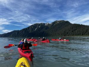 Families enjoying kayaking together on a family vacation in Alaska