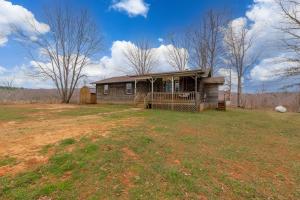 3 BR/1.5 BA home on 12.03 +/- acres (2 parcels for one money) -- 2 wells that serve the 3 BR home and mobile home (potentially salvageable) -- Excellent potential for a primary residence & rental property