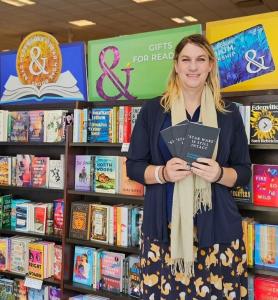 Alysha Scarlett poses at Barnes & Noble with three copies of her book, 